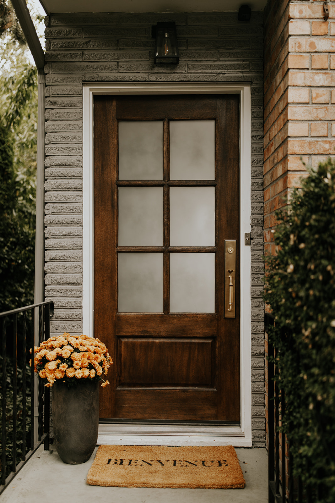Front door of the Fairhaven Home with a Grandeur Entry set as the hardware, solid wood and frosted glass