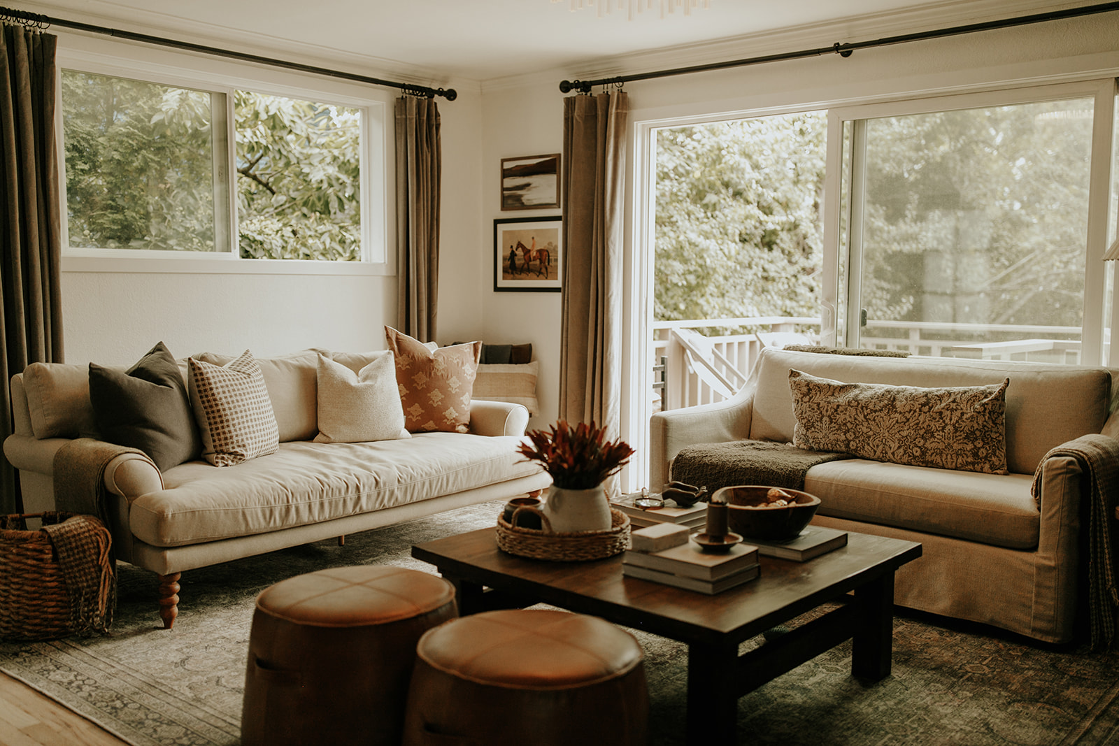 The living room in the Fairhaven Home, with two couches, pillows, a coffee table and curtains